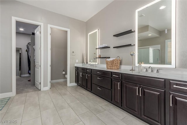 8 Via Tiberina, Las Vegas, NV 89011 - bathroom with double vanity, a shower stall, toilet, and baseboards