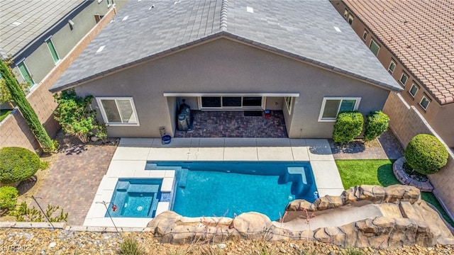 8 Via Tiberina, Las Vegas, NV 89011 - back of house with stucco siding, a fenced backyard, a patio, and a pool with connected hot tub