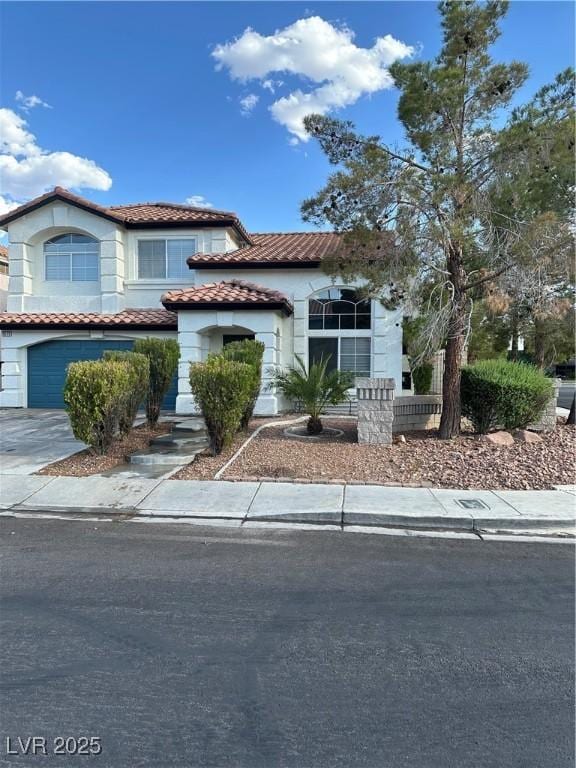 1511 Balsam Mist Ave, Las Vegas, NV 89183 - view of front of property with a tile roof, an attached garage, concrete driveway, and stucco siding
