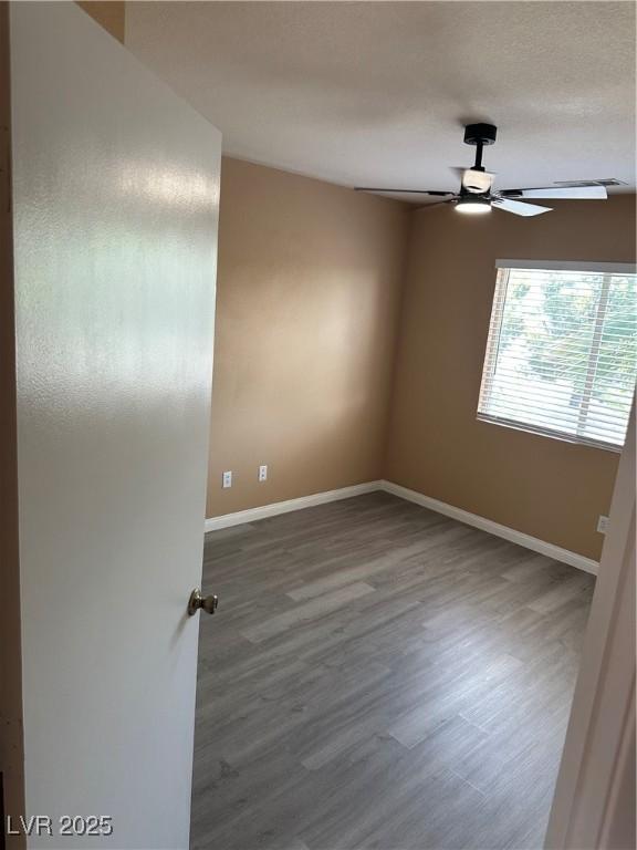 1511 Balsam Mist Ave, Las Vegas, NV 89183 - spare room with baseboards, wood finished floors, and ceiling fan