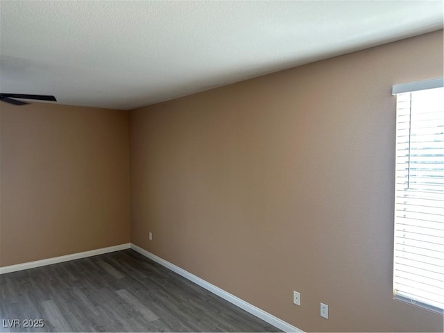 1511 Balsam Mist Ave, Las Vegas, NV 89183 - spare room featuring dark wood-type flooring and baseboards