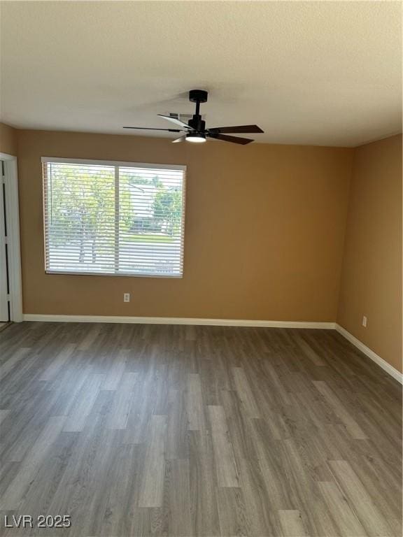 1511 Balsam Mist Ave, Las Vegas, NV 89183 - spare room with wood finished floors, healthy amount of natural light, and baseboards