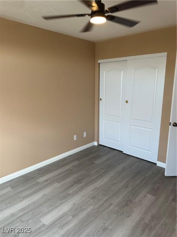 1511 Balsam Mist Ave, Las Vegas, NV 89183 - unfurnished bedroom featuring wood finished floors, a closet, baseboards, and ceiling fan