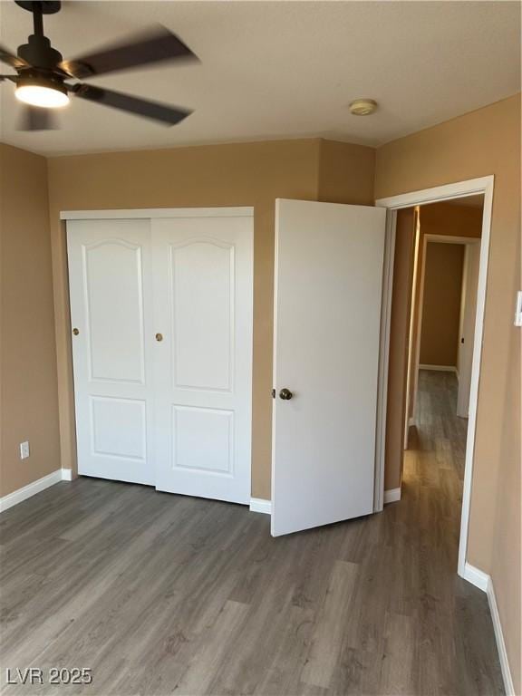 1511 Balsam Mist Ave, Las Vegas, NV 89183 - unfurnished bedroom featuring wood finished floors, baseboards, a closet, and a ceiling fan