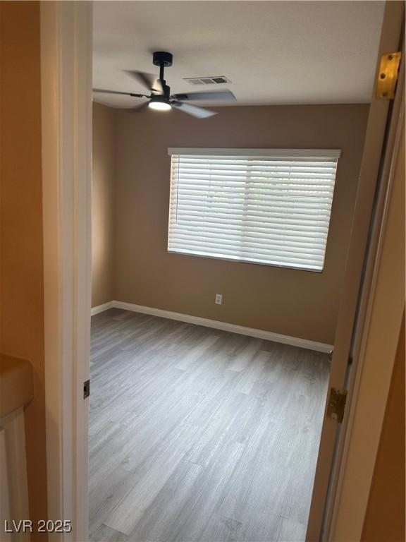 1511 Balsam Mist Ave, Las Vegas, NV 89183 - spare room with a ceiling fan, wood finished floors, and baseboards