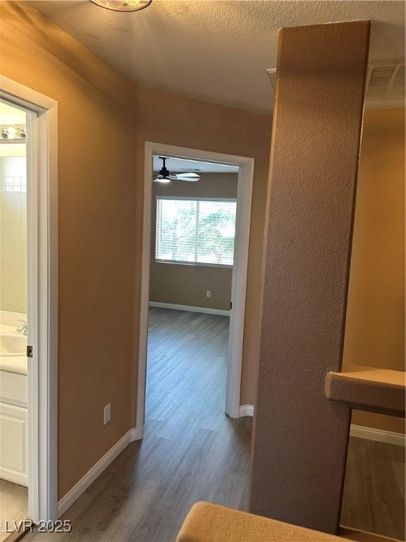 1511 Balsam Mist Ave, Las Vegas, NV 89183 - corridor featuring wood finished floors, baseboards, and a sink