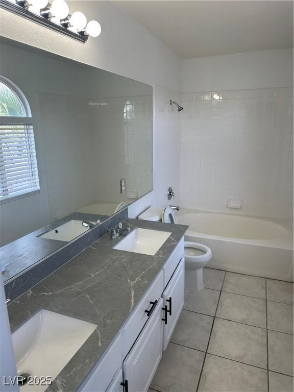 1511 Balsam Mist Ave, Las Vegas, NV 89183 - bathroom featuring double vanity, toilet, tile patterned flooring, and bathtub / shower combination