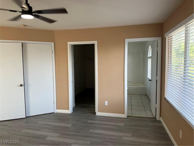 1511 Balsam Mist Ave, Las Vegas, NV 89183 - unfurnished bedroom with a closet, connected bathroom, wood finished floors, and baseboards
