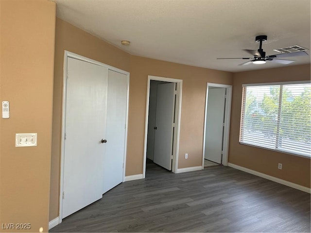 1511 Balsam Mist Ave, Las Vegas, NV 89183 - unfurnished bedroom featuring baseboards, dark wood-style flooring, a closet, and ceiling fan