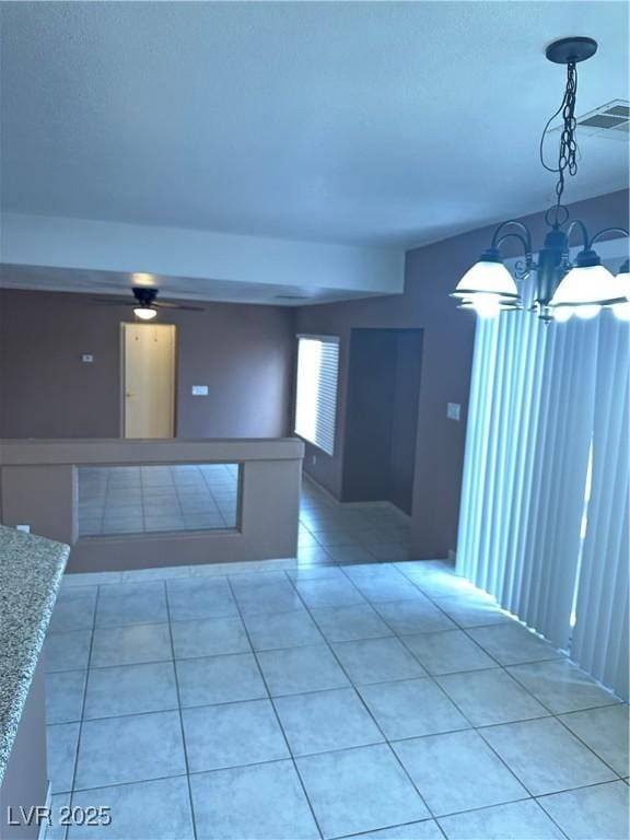 1511 Balsam Mist Ave, Las Vegas, NV 89183 - spare room with a chandelier, light tile patterned flooring, and a ceiling fan