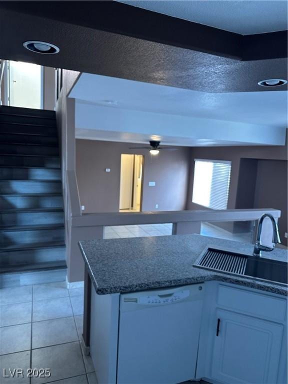 1511 Balsam Mist Ave, Las Vegas, NV 89183 - kitchen featuring white dishwasher, a sink, white cabinets, light tile patterned floors, and ceiling fan