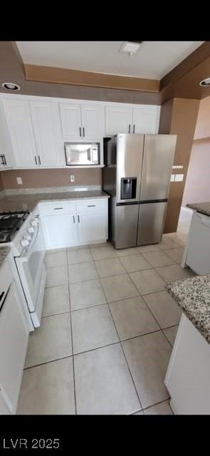 1511 Balsam Mist Ave, Las Vegas, NV 89183 - kitchen with white appliances, white cabinetry, and light tile patterned flooring