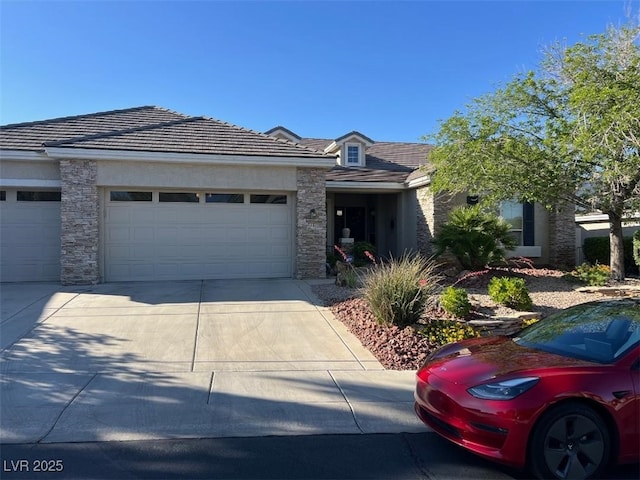 10816 Elm Ridge Ave, Las Vegas, NV 89144 - view of front facade featuring stone siding, a garage, and concrete driveway