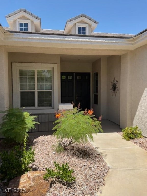 10816 Elm Ridge Ave, Las Vegas, NV 89144 - doorway to property featuring stucco siding and a porch