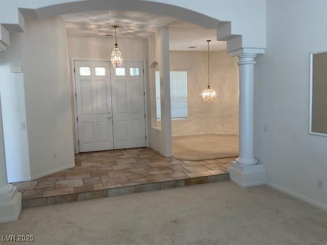 10816 Elm Ridge Ave, Las Vegas, NV 89144 - carpeted foyer entrance with arched walkways, a chandelier, and baseboards