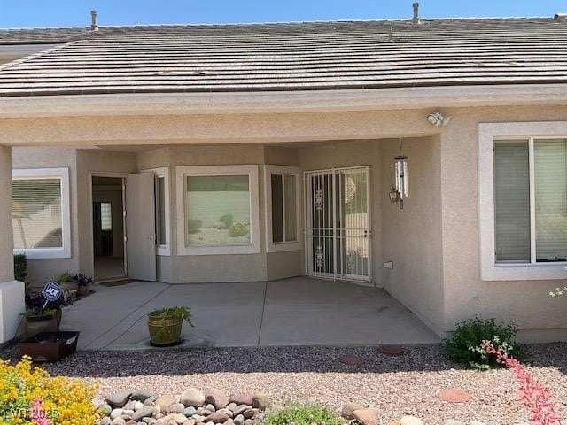 10816 Elm Ridge Ave, Las Vegas, NV 89144 - doorway to property with a patio area and stucco siding