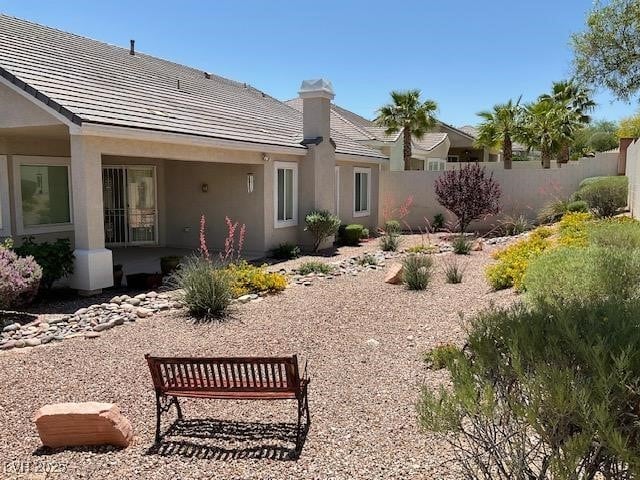 10816 Elm Ridge Ave, Las Vegas, NV 89144 - rear view of house featuring stucco siding and a chimney
