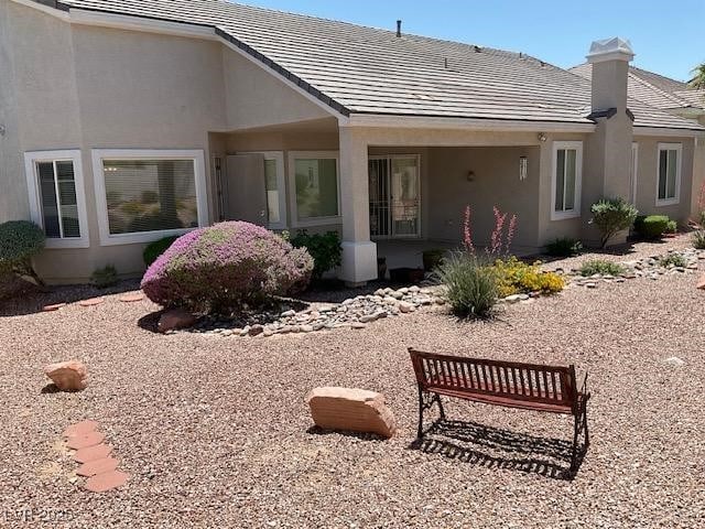 10816 Elm Ridge Ave, Las Vegas, NV 89144 - rear view of house with a chimney and stucco siding