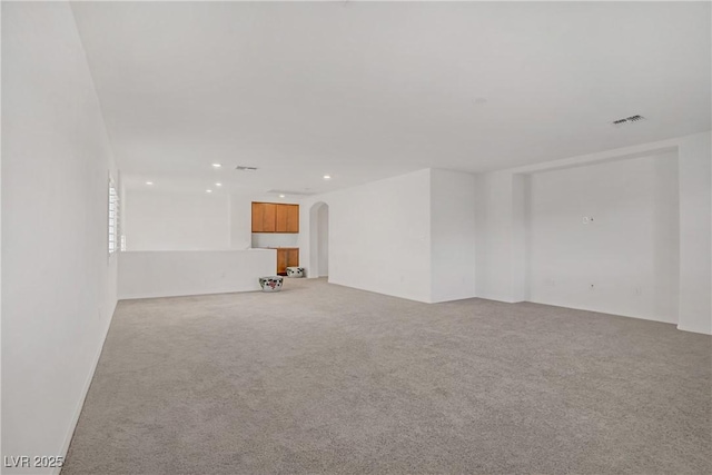 7255 Bold Rock Ave, Las Vegas, NV 89113 - unfurnished room with light carpet, arched walkways, and recessed lighting
