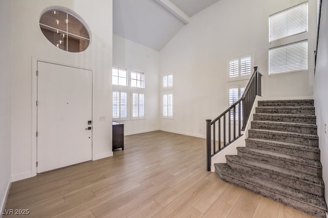 722 Descartes Ave, Henderson, NV 89002 - foyer entrance featuring high vaulted ceiling, stairs, wood finished floors, and baseboards
