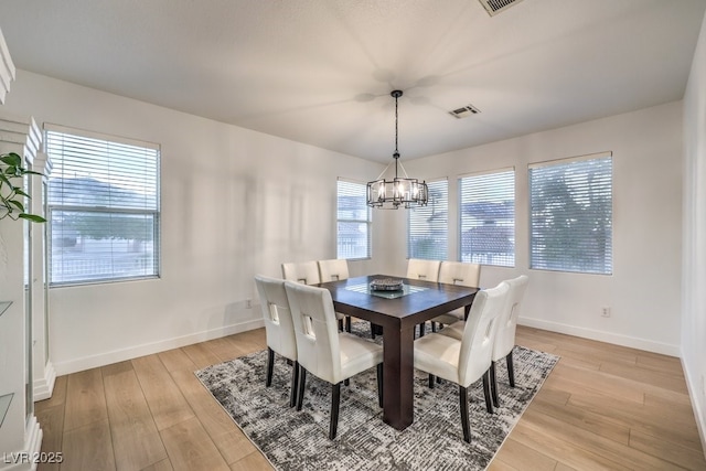 722 Descartes Ave, Henderson, NV 89002 - dining area with a chandelier, baseboards, and light wood-type flooring