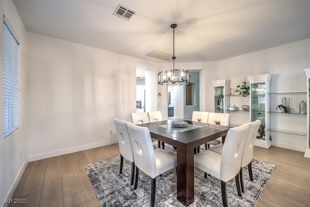 722 Descartes Ave, Henderson, NV 89002 - dining space featuring a chandelier, light wood-style floors, baseboards, and healthy amount of natural light
