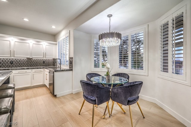 722 Descartes Ave, Henderson, NV 89002 - dining room with healthy amount of natural light, light wood-type flooring, a chandelier, recessed lighting, and baseboards