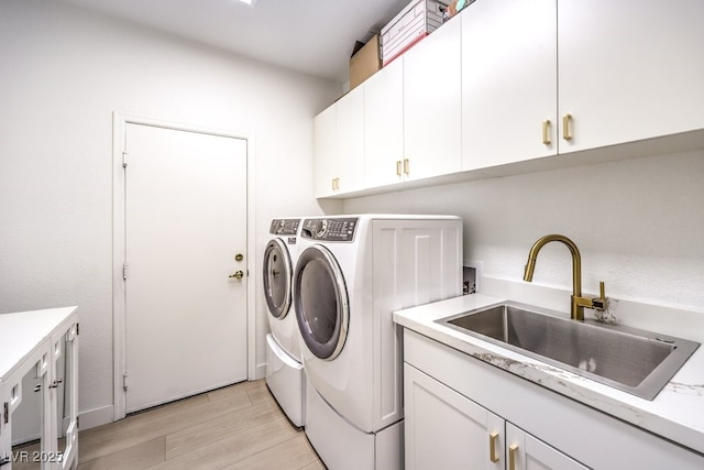 722 Descartes Ave, Henderson, NV 89002 - washroom featuring separate washer and dryer, cabinet space, and light wood-style flooring