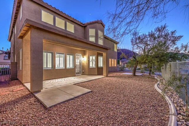 722 Descartes Ave, Henderson, NV 89002 - back of house featuring stucco siding, a tiled roof, a fenced backyard, and a patio