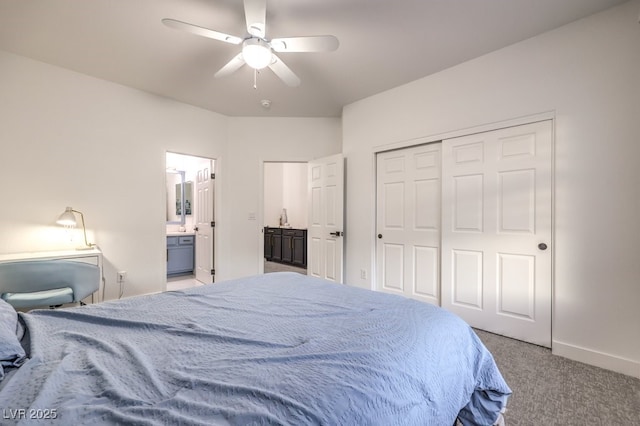 722 Descartes Ave, Henderson, NV 89002 - carpeted bedroom featuring a closet, ensuite bathroom, baseboards, and ceiling fan
