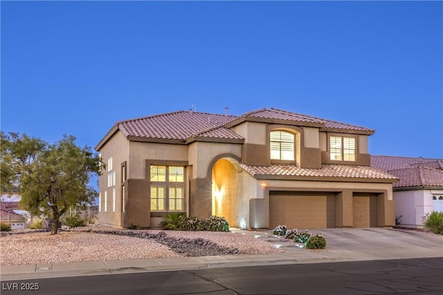 722 Descartes Ave, Henderson, NV 89002 - mediterranean / spanish-style home featuring stucco siding, driveway, an attached garage, and a tile roof