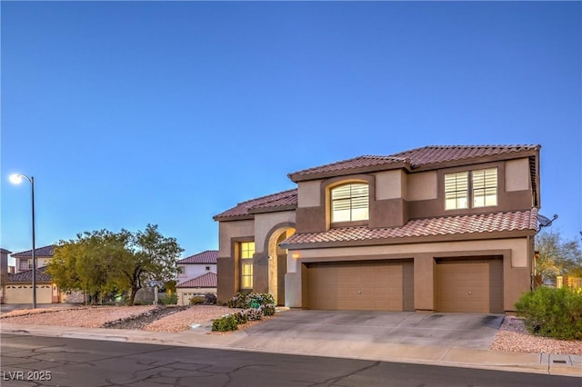 722 Descartes Ave, Henderson, NV 89002 - mediterranean / spanish home with stucco siding, a tiled roof, an attached garage, and driveway