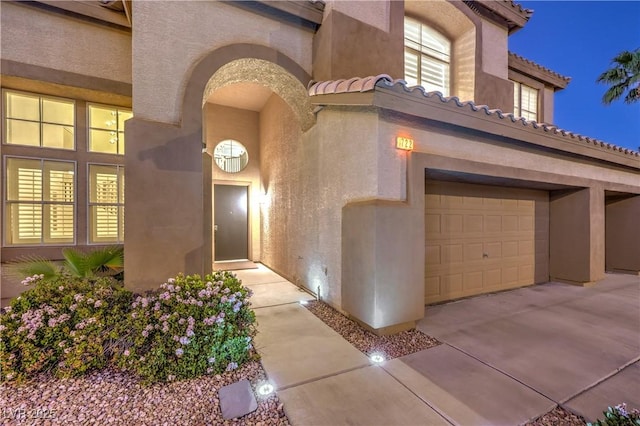 722 Descartes Ave, Henderson, NV 89002 - entrance to property with a garage, a tiled roof, and stucco siding