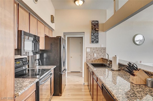 2496 Golfers St, Las Vegas, NV 89142 - kitchen featuring electric stove, a sink, black microwave, light stone countertops, and light wood-style flooring