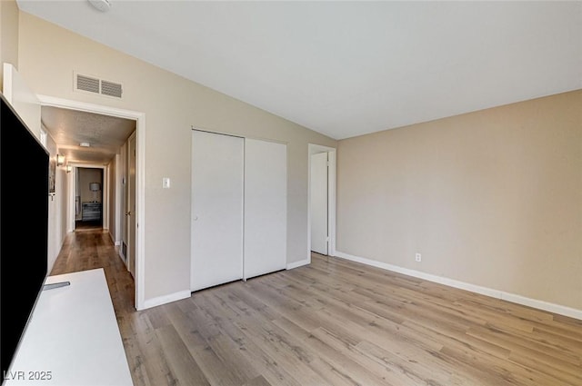 2496 Golfers St, Las Vegas, NV 89142 - unfurnished bedroom with wood finished floors, lofted ceiling, baseboards, and a closet