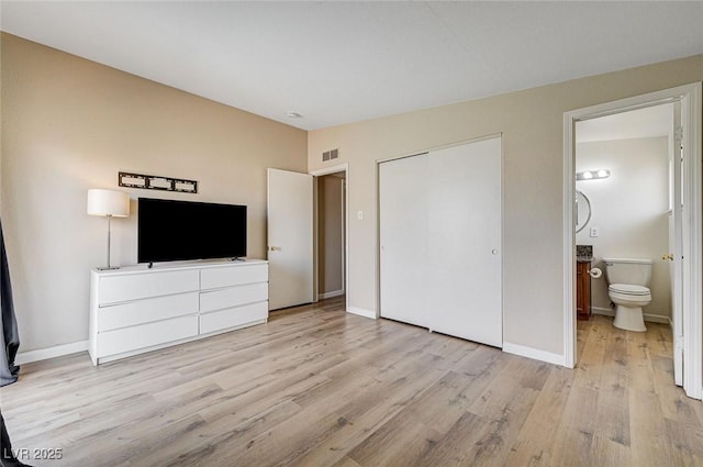 2496 Golfers St, Las Vegas, NV 89142 - unfurnished bedroom with light wood-style flooring, baseboards, ensuite bath, and a closet