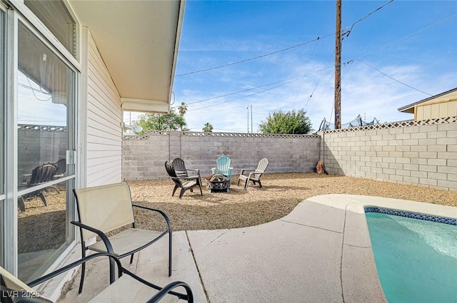 2496 Golfers St, Las Vegas, NV 89142 - fenced backyard featuring a fire pit, a patio, and an outdoor pool