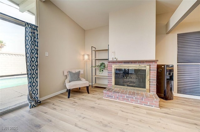 2496 Golfers St, Las Vegas, NV 89142 - living area featuring baseboards, wood finished floors, lofted ceiling, and a fireplace
