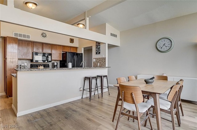 2496 Golfers St, Las Vegas, NV 89142 - dining room with lofted ceiling and light wood finished floors