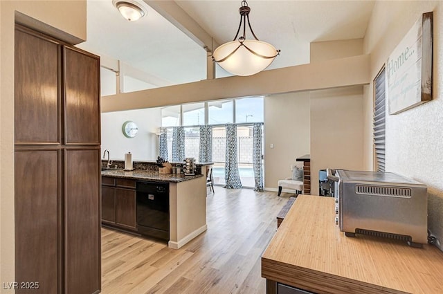 2496 Golfers St, Las Vegas, NV 89142 - kitchen featuring black dishwasher, light wood-type flooring, a sink, dark brown cabinetry, and a peninsula