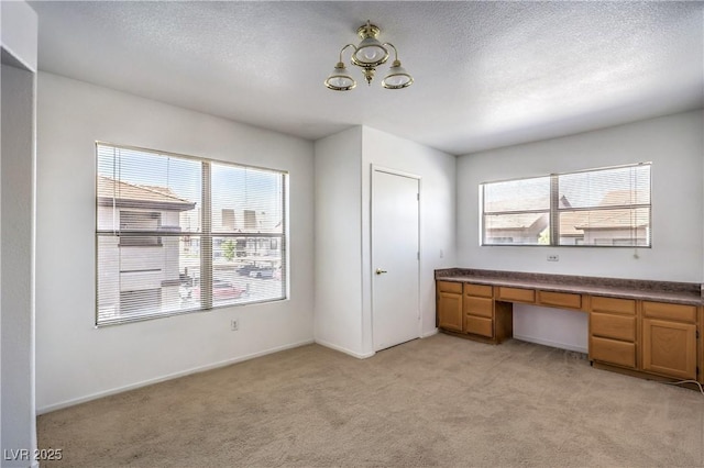45 Maleena Mesa St Unit 1321, Henderson, NV 89074 - unfurnished office with light carpet, a chandelier, a textured ceiling, and built in study area