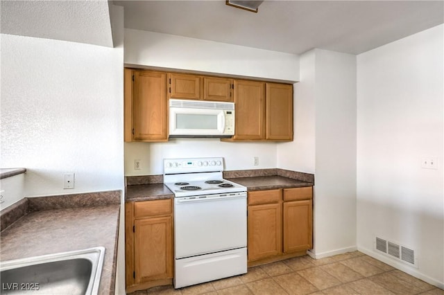 45 Maleena Mesa St Unit 1321, Henderson, NV 89074 - kitchen with white appliances, dark countertops, and brown cabinets