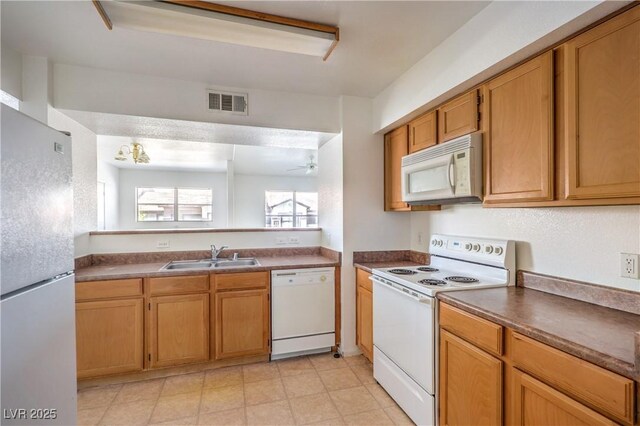 45 Maleena Mesa St Unit 1321, Henderson, NV 89074 - kitchen with white appliances, ceiling fan, dark countertops, and brown cabinetry