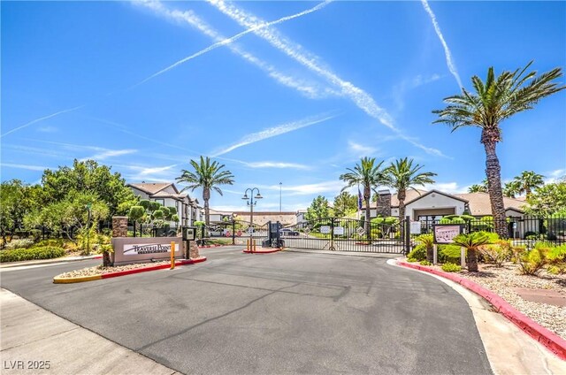 45 Maleena Mesa St Unit 1321, Henderson, NV 89074 - view of asphalt road featuring a gate, curbs, a gated entry, street lighting, and a residential view