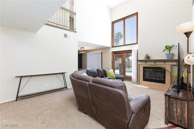 9817 Dardanelle Ct, Las Vegas, NV 89117 - carpeted living room featuring a towering ceiling, a tiled fireplace, and baseboards