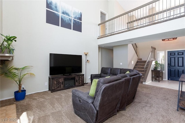 9817 Dardanelle Ct, Las Vegas, NV 89117 - carpeted living room featuring a towering ceiling, stairway, and baseboards