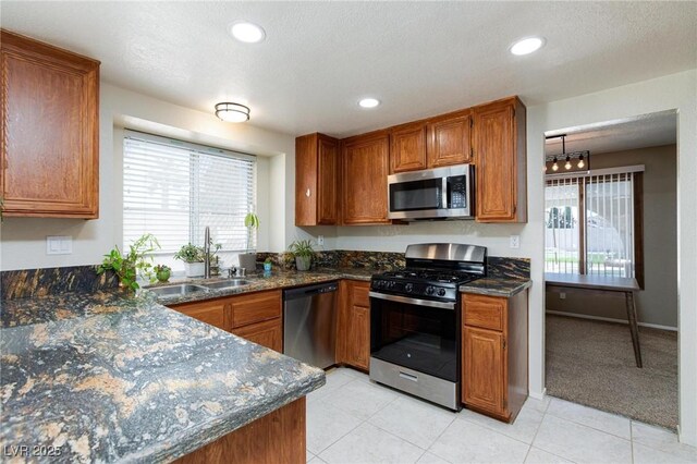 9817 Dardanelle Ct, Las Vegas, NV 89117 - kitchen with appliances with stainless steel finishes, a sink, brown cabinets, and recessed lighting