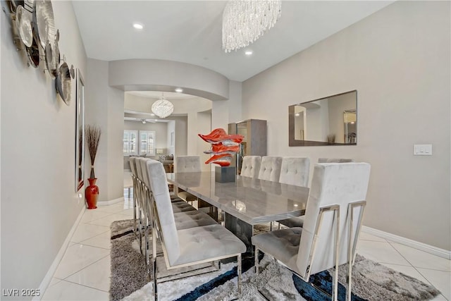 3155 Dalmazia Ave, Henderson, NV 89044 - dining room featuring arched walkways, a chandelier, baseboards, light tile patterned floors, and recessed lighting