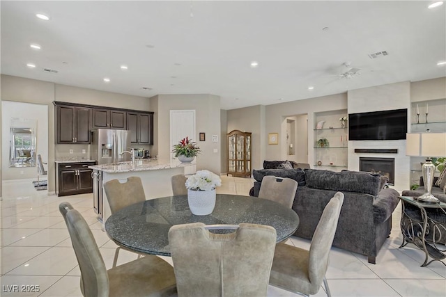 3155 Dalmazia Ave, Henderson, NV 89044 - dining area featuring light tile patterned floors, recessed lighting, a large fireplace, baseboards, and a ceiling fan
