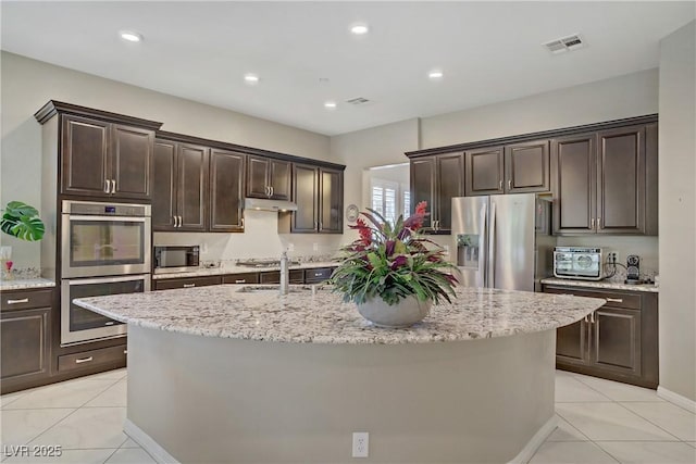 3155 Dalmazia Ave, Henderson, NV 89044 - kitchen featuring stainless steel appliances, a sink, light tile patterned floors, dark brown cabinetry, and recessed lighting